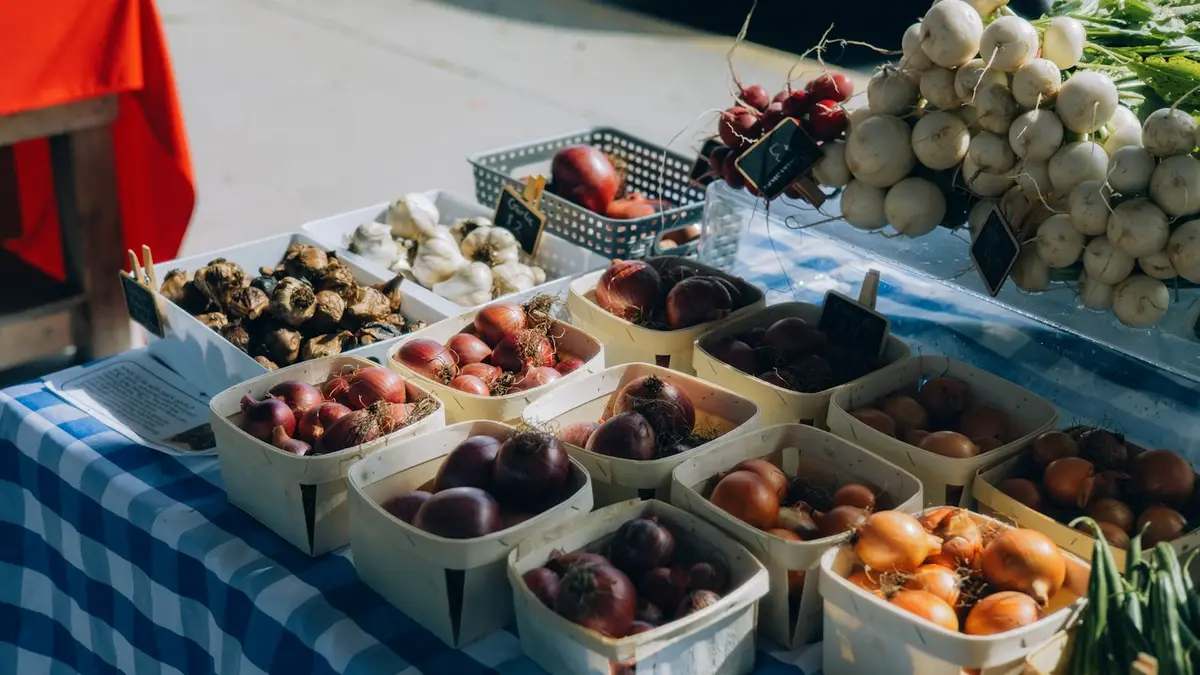 Baskets of fresh vegetables on a market stall